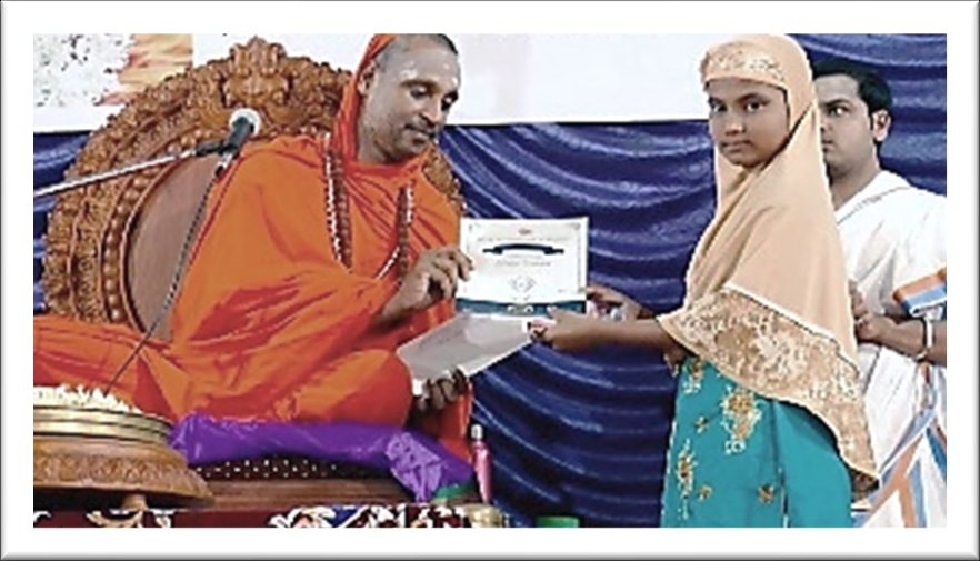 A student receiving a scholarship from Sri Yogi